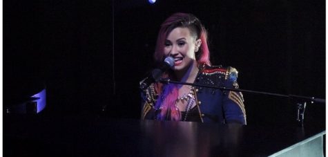 Photo / Michelle Lensing Pop star performer Demi Lovato sings "Warrior" as she plays the piano.