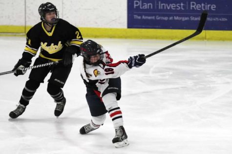 Brooklyn Duffy does a slap shot at a Hutchinson tiger goalie