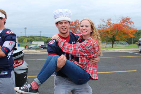 Homecoming king and queen pose for a picture before the parade