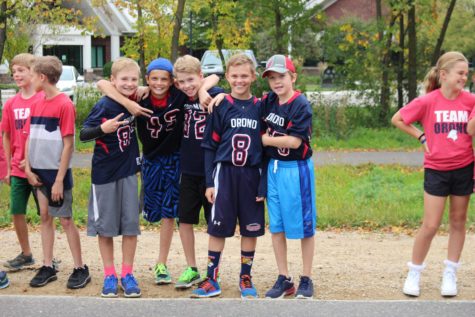 Intermediate school pals pose for a picture while watching the parade