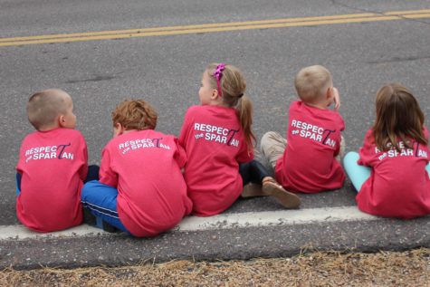 The Schumann Elementary kids watch the parade as they sport their new Homecoming shirts 