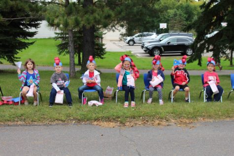 O.K. kids show off their Homecoming hats as they watch the parade