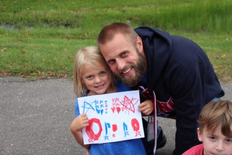 Mr. Porter watched the parade alongside his daughter