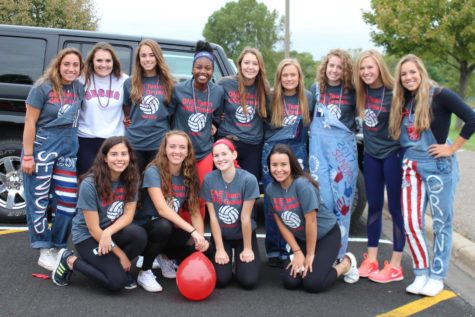 The volleyball girls pose for a picture before the parade begins