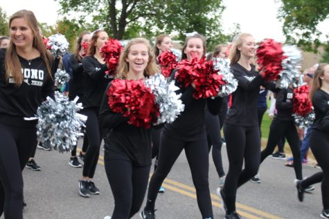 Seniors Alexa Eichstadt and Quinn Crandall use their pom poms to pump up the crowd