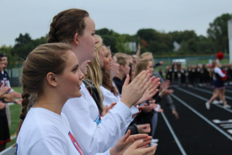 The fall sports captains help cheer on the crowd