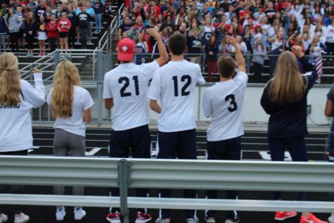 The soccer captains get the crowd going during the Rowdy cheer