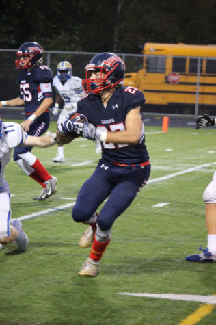 Senior Luke Greenagel runs the ball down to the end zone on Homecoming night.