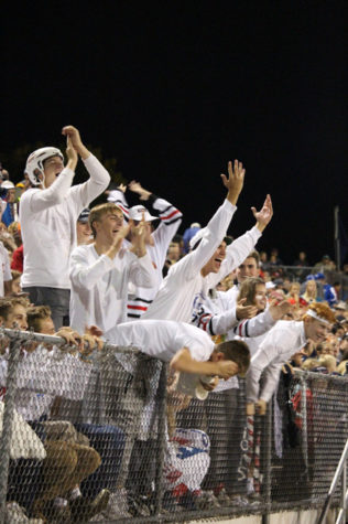 Senior boys cheer on the home team.