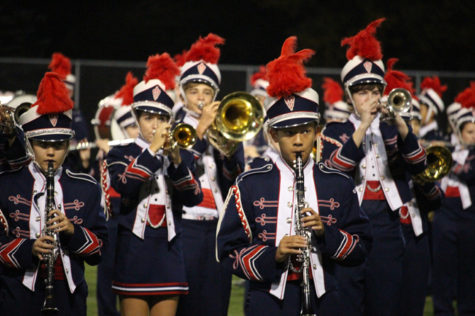 The band plays on the field at halftime. 