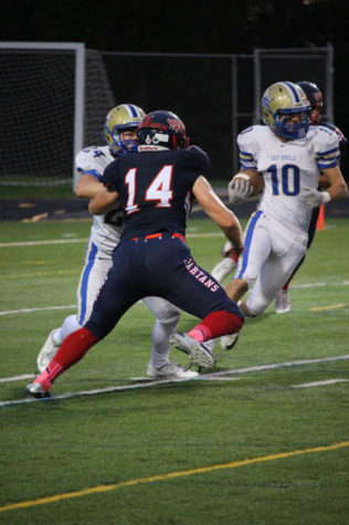 Junior Caleb Olson keeps his eye on the ball while defending his home team.