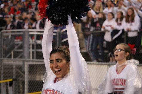 Freshman Rae Malik engages in the cheer with her bright smile and radiating spartan spirit.