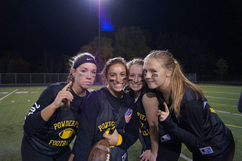 Senior ladies pose on the field before the game. 