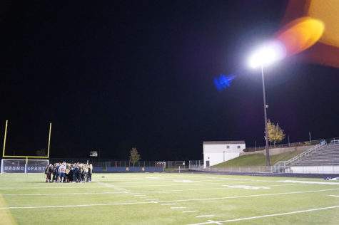 The senior team takes their final cheer before the game. 