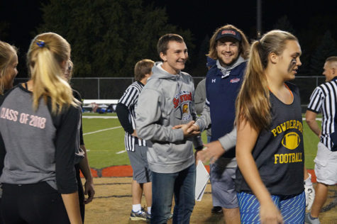 Junior coach Brendan Prentice shakes senior coach Cody Quast’s hand in a friendly gesture before the game. 