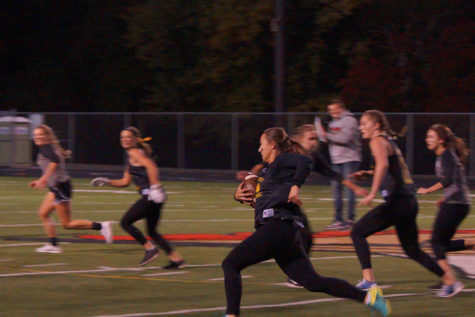 Senior runningback Emma Sternberg takes the ball down the field to score the team’s first touchdown. 