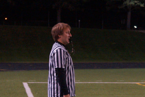 Referee Jarrett Lundquist blows the whistle. 