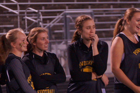 Seniors Maddie Marquis, Grace Leslie and Paige Condon watch hesitantly from the side. 