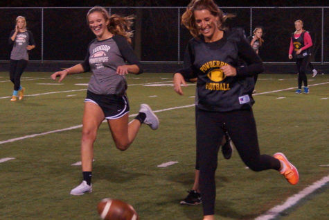 Senior Alexa Leischow and Junior Lily Peterson smile as the ball fumbles to the ground. 