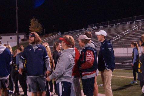 The many senior coaches confer on the sidelines. 