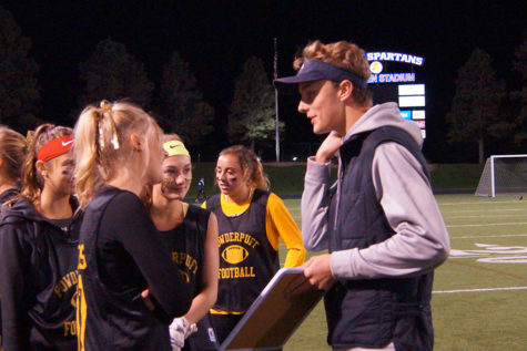 Senior Katie Kimmes confers the coach Trevor Paul about game strategy. 