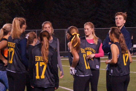 Eiss looks to his co-coaches for advice during a senior huddle. 