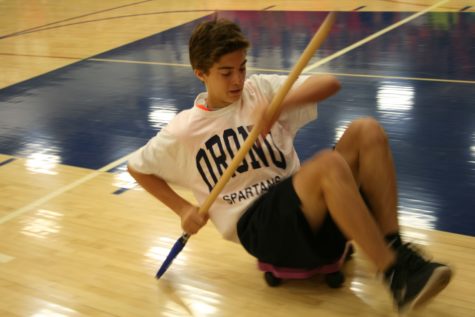 Sam Bazil scoots across the floor during the relay