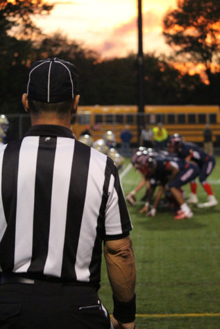 The referee anticipates the next play on the field.