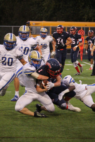 Orono quarterback Nick Prentice keeps the ball in his possession. 