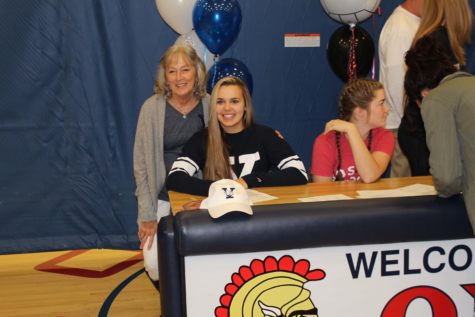 Tori Andrew poses with a family member after signing