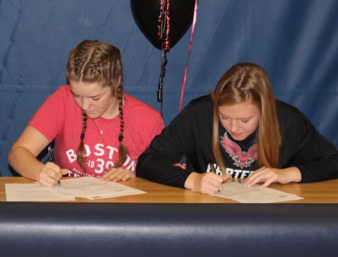 Seniors Sam Fischer and Megan Anderson sign their letters of intent side-by-side