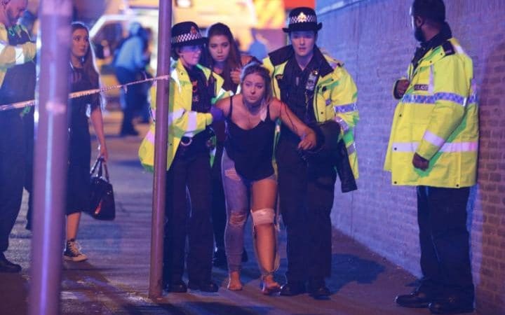 Officials+assist+the+wounded+after+an+explosion+targeted+fans+leaving+Ariana+Grande+concert+at+the+Manchester+Arena+in+England+on+Monday+night.+Joel+Goodman+%2F+REX%2FShutterstock+via+AP